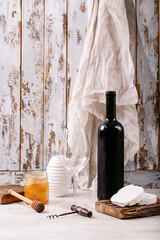 Goat cheese served with honey and bottle of red wine