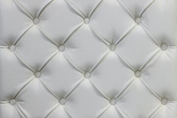 Fototapeta na wymiar luxury seamless background texture close up white leather material with buttons on furniture