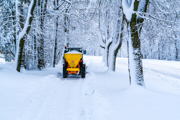 Tractor de-icing street, spreading salt.