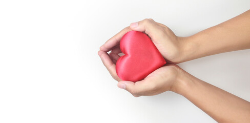 Hands holding  red heart. heart health donation concepts