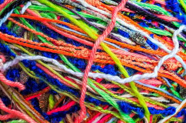 beautiful textured background of a tangle of multicolored yarn threads of different colors and thicknesses