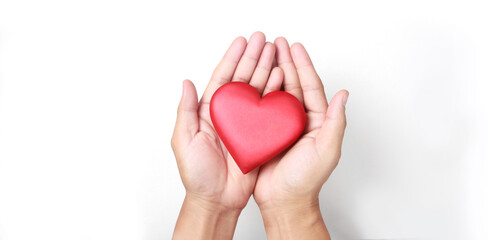 Hands holding  red heart. heart health donation concepts
