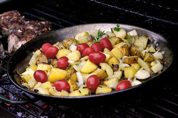Fried potatoes with onion and mini-tomatoes.