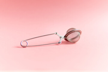 strainer on a pink background