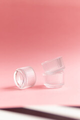 glass jars on a pink background. fashion background