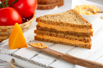 Delicious sandwiches with cheddar cheese, tomatoes and onions on wholewheat rye bread with flax...