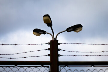 Obraz premium Lamppost and Barbwire