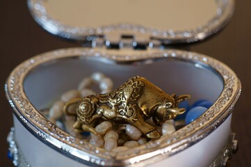 Metal bull and jewelry close-up.