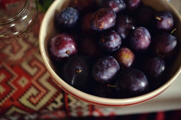 plums in a bowl on the table. organic tasty fruits from the orchard