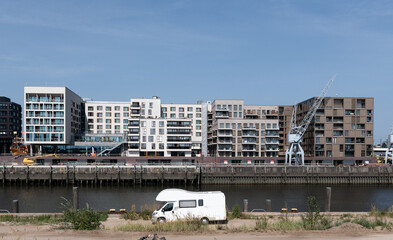 A caravan in front of modern Architecture as a symbol of travel in cities.