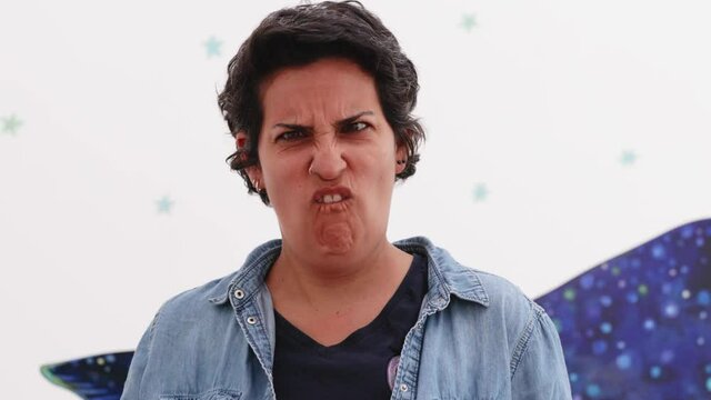 portrait of attractive latino woman doing a grimace in slow motion