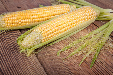 Corn on the cob on a wooden background. View from another angle in the portfolio.
