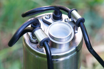 The top of the well pump with black cable. The outlet thread of the downhole pump. The pump thread...
