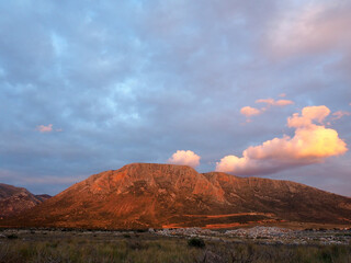 A mountain in Mani, Greece, painted in colours by dusk