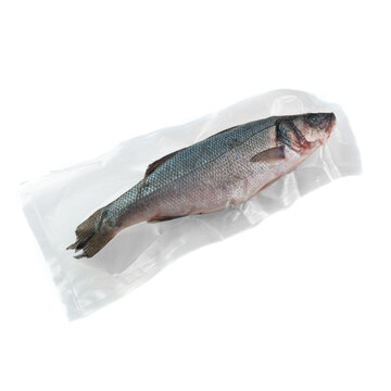 Frozen sea bass. In plastic vacuum packaging. White background. Isolated. View from above.