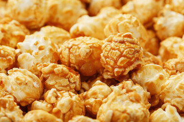 Caramel popcorn close-up as a background, full-screen texture.