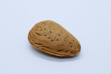 Close up view of non peeled almond. White background.