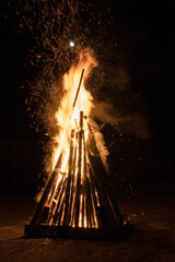 large bonfire with moon above