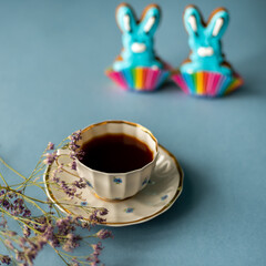 Blue easter bunny gingerbread cookie with a cup of coffee