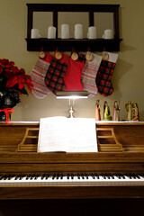 Christmas Decorations on Piano with Stockings and Music