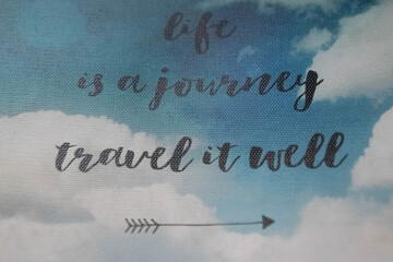 Life is a journey travel well on cloudy sky background close up
