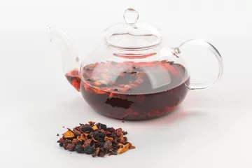 Foto op Aluminium Heap of dried fruit pieces and a glass teapot with steeped tea © yuriygolub