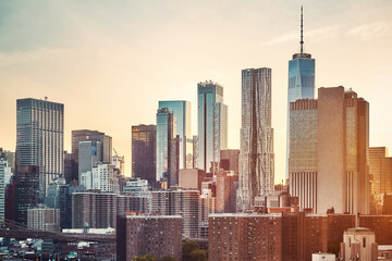 Fototapeta na wymiar Manhattan skyline at golden sunset, color toning applied, New York City, USA.