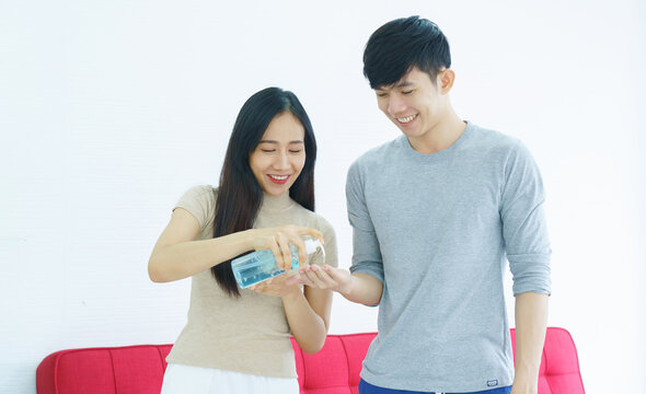 Asian Family Are Using Alcohol Gel To Wash Their Hands Thoroughly To Prevent Dirt. And The Spread Of COVID-19. Couple Are Happy To Live Together In A Healthy Relationship. Concept Health Care