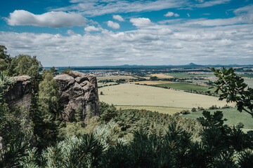 scenic landscape with rocks, field and forest
