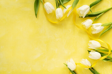 Beautiful white tulips on a yellow background. Spring flowers background top view. Banner with copy space