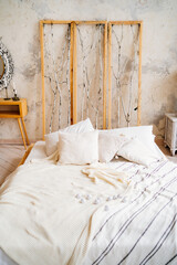 Loft interior. a bed with an unusual headboard. make-up table with a mirror