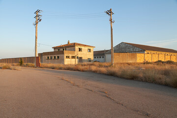 Fototapeta na wymiar Facilities, already abandoned for decades, of the old paper industry of Gallur, Aragon, Spain. Example of crisis and depopulation of the territory.