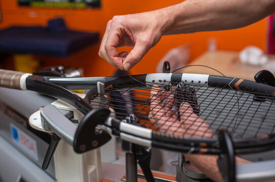 Process of stringing a tennis racket in a tennis shop, sport and leisure concept