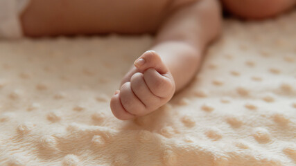 Tiny newborn 2 months or 6 weeks old baby's hand. Close-up baby's fistSelective focus