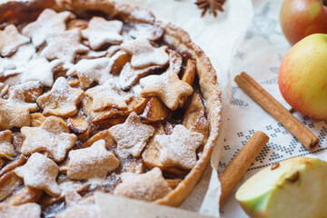 Traditional apple pie on the table with decorations. 