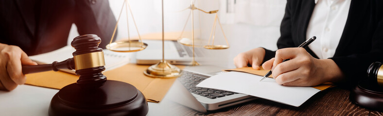 Justice and law concept.Male judge in a courtroom with the gavel, working with, computer and...
