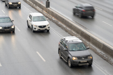 Fototapeta na wymiar Russia, Moscow, January 08, 2021, Heavy traffic on the Moscow ring road, blurred silhouettes of cars when driving fast on the highway