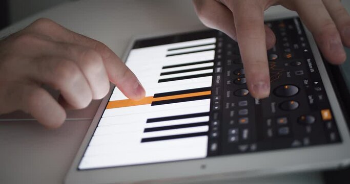 User plays digital piano synth on a tablet application music production software