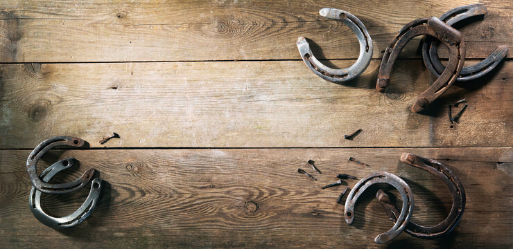 Old rusty horse shoes on barn floor
