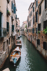 Fototapeta na wymiar Canal with boats between old houses in Venice, Italy