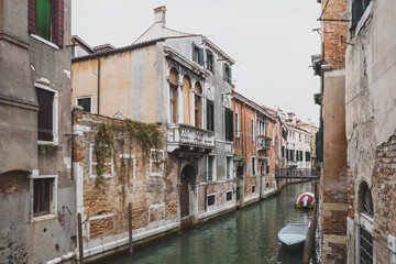 Fototapeta na wymiar Canal with boats between old houses in Venice, Italy