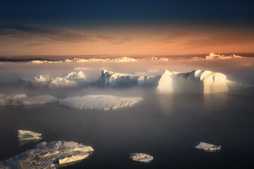 floating glaciers in the rays of the setting sun during a polar night