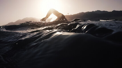 Athletic young man swimming at sea. Professional triathlon swimmer in ocean water. Young man...