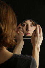 Mirror reflection of a woman's face, studio shot