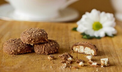 Shortbread cookies chocolate glazed sliced and crumbs on wooden table background. Round shortbread cookies bar with chocolate chips - eat dessert concept. Shortbread cookies or shortcake in chocolate