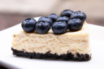 Homemade creamy cheese pie with fresh blueberries on top.