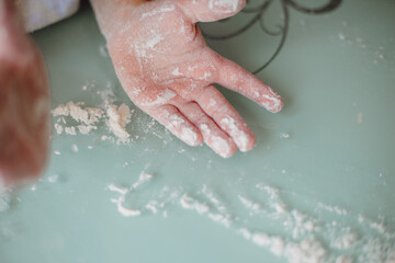 Child's hand covered with flour