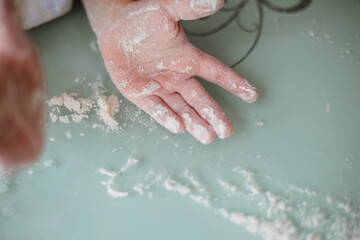 Fototapeta premium Child's hand covered with flour
