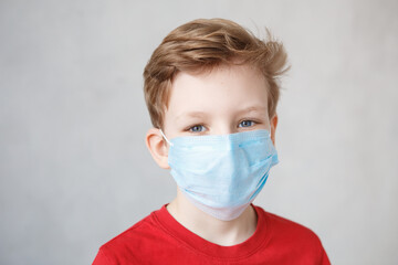 Little boy wearing a mask against corona virus covid-19, 2019-nCov. Kid in a surgical bandage or respirator during corona virus and flu outbreak. Child in a medical mask. quarantine.