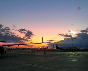 Aircraft on the airfield in the evening during sunset